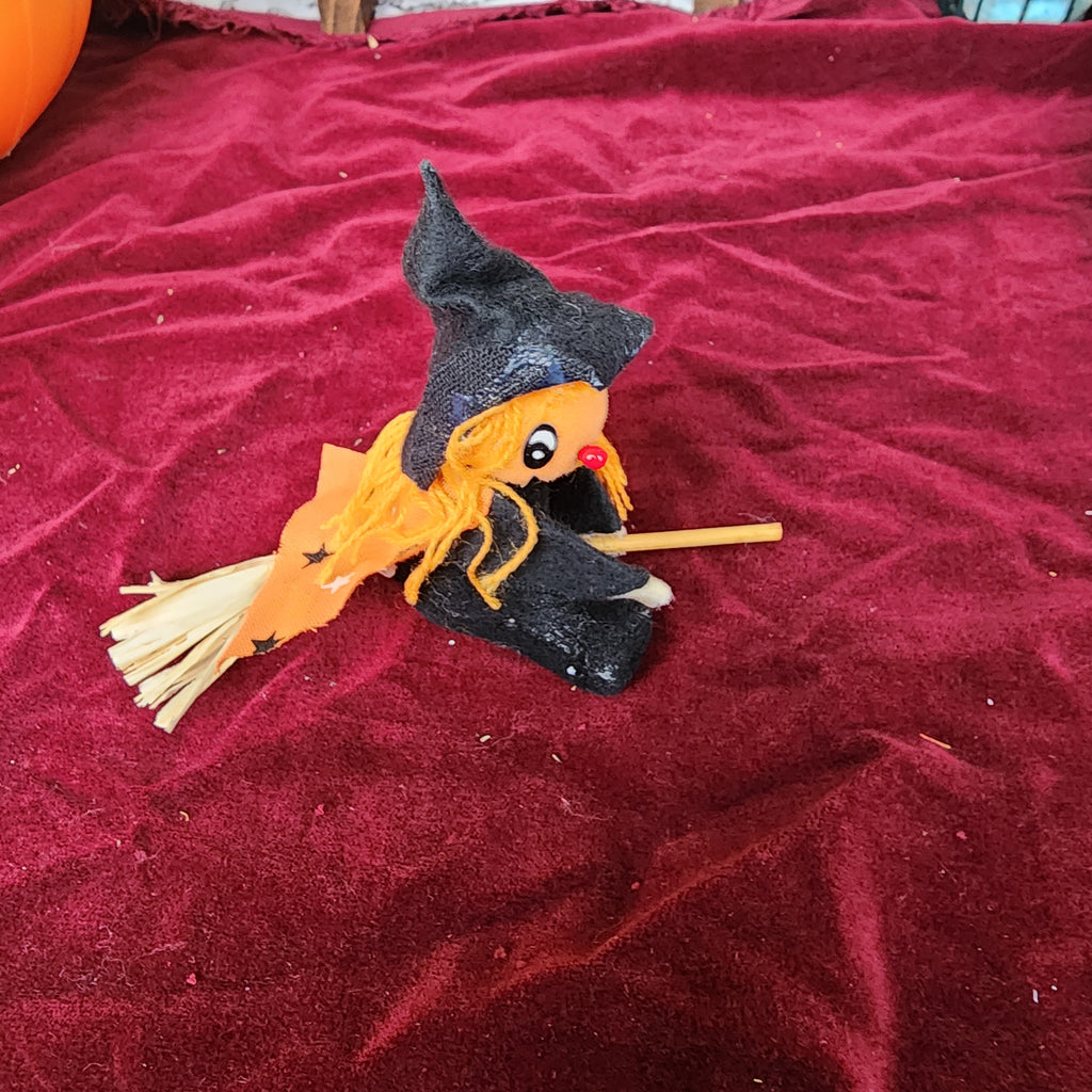 Little pumpkin witch on a broom