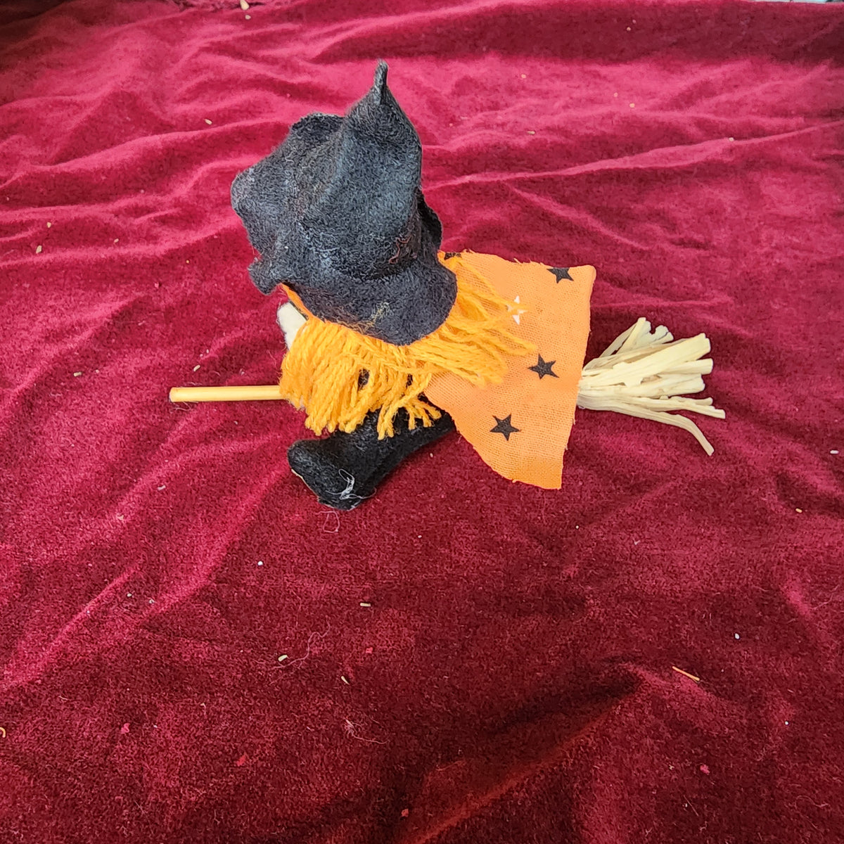 Little pumpkin witch on a broom